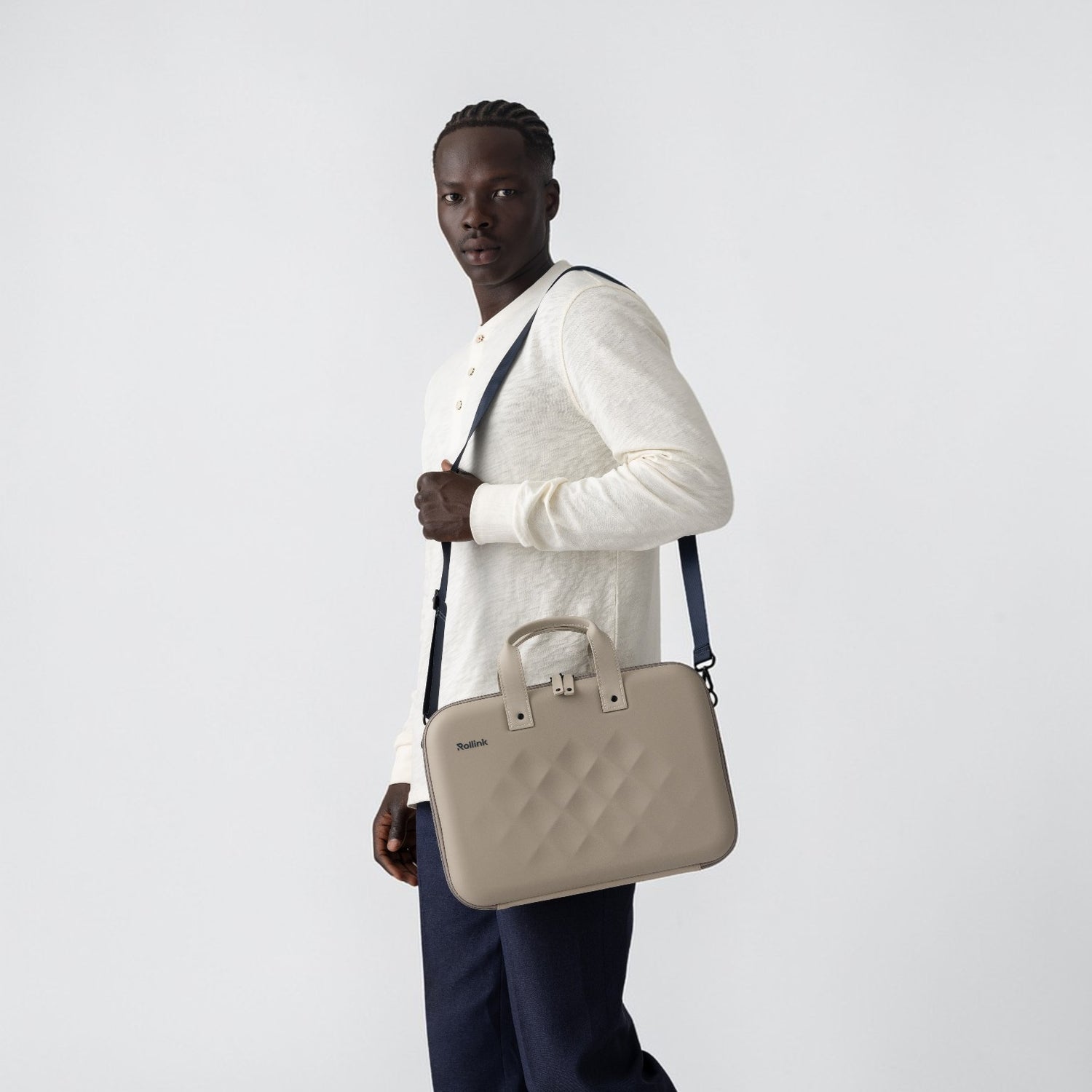 Man holding Rollink Laptop case tour in stone 